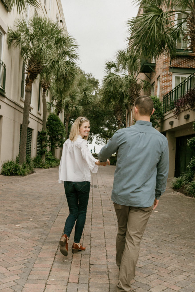 couple walking holding hands in Charleston, SC