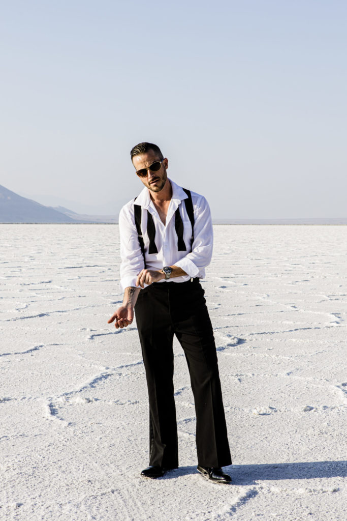 James Bond suiting on model on Salt Flats fixing collar