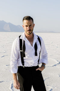 James Bond suiting on model on Salt Flats fixing collar