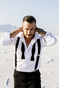 James Bond suiting on model on Salt Flats fixing collar