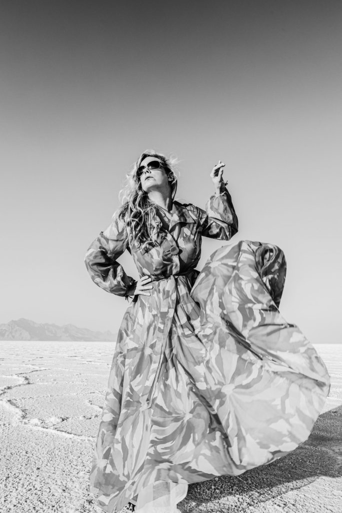 beautiful model in gown dancing on the salt flats