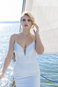 bride standing on bow of sailboat in a wedding dress on Hilton Head Island