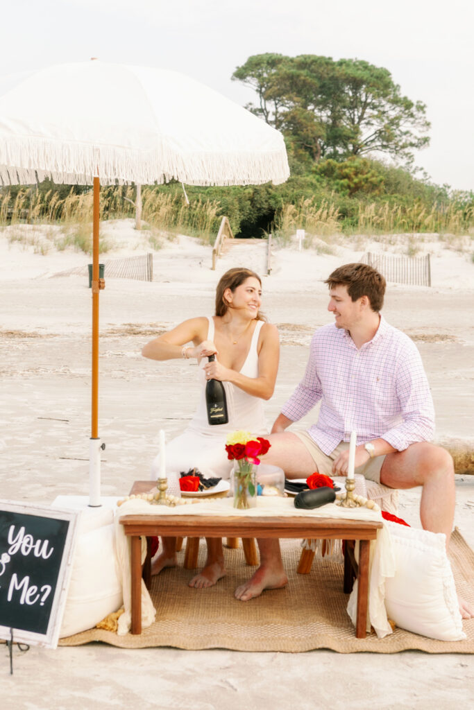 Marriage proposal photography on the beach in Hilton Head with a picnic set up