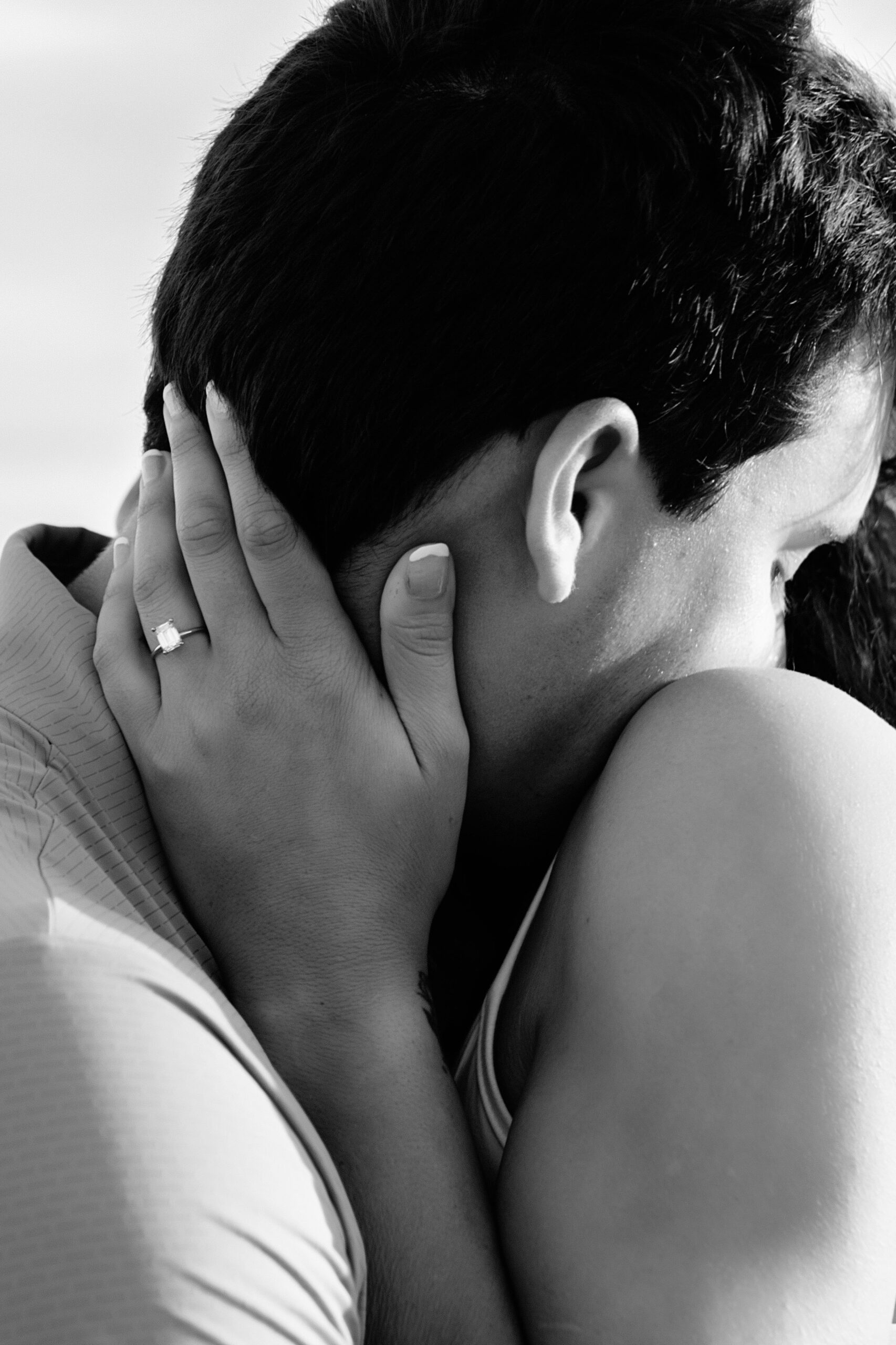 Engaged couple embracing on the beach in Hilton Head