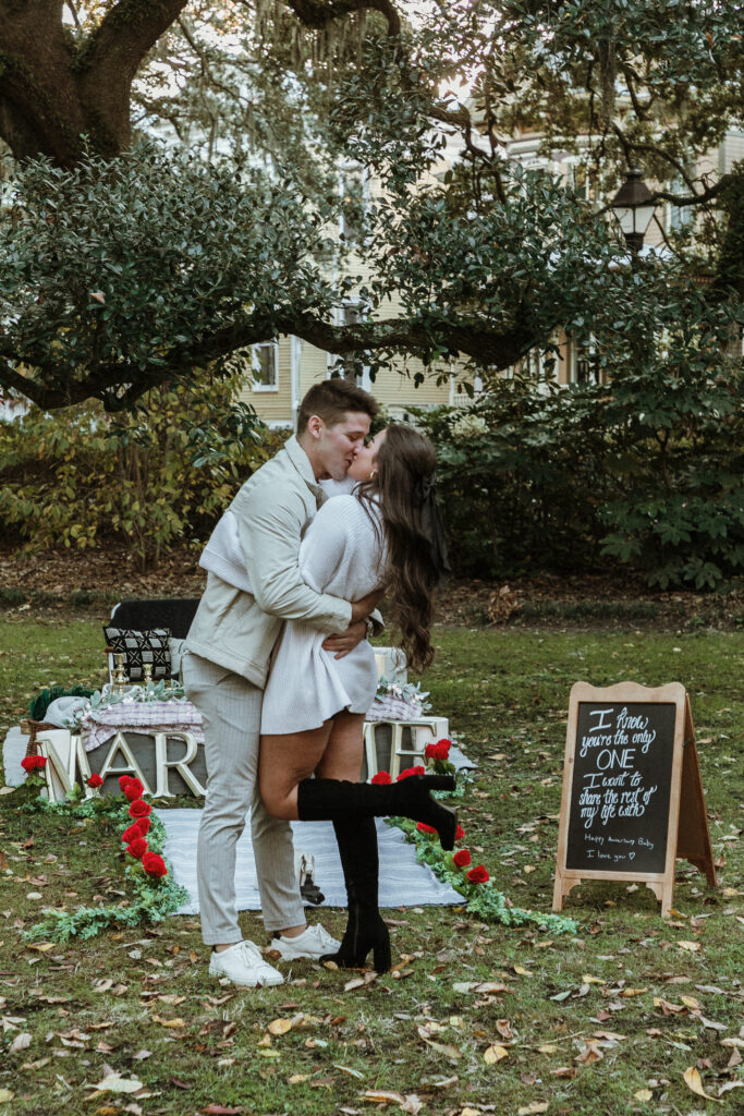 Marriage proposal capture by photographer Lisa Staff with picnic set up at Forsyth Park, Savannah