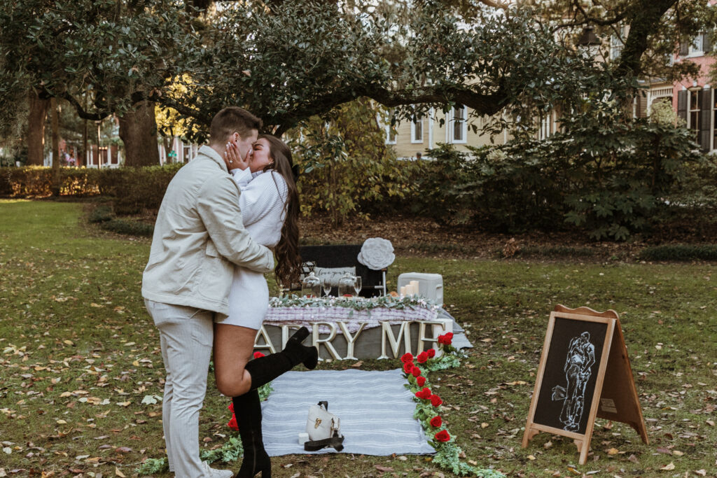 Marriage proposal capture by photographer Lisa Staff with picnic set up at Forsyth Park, Savannah