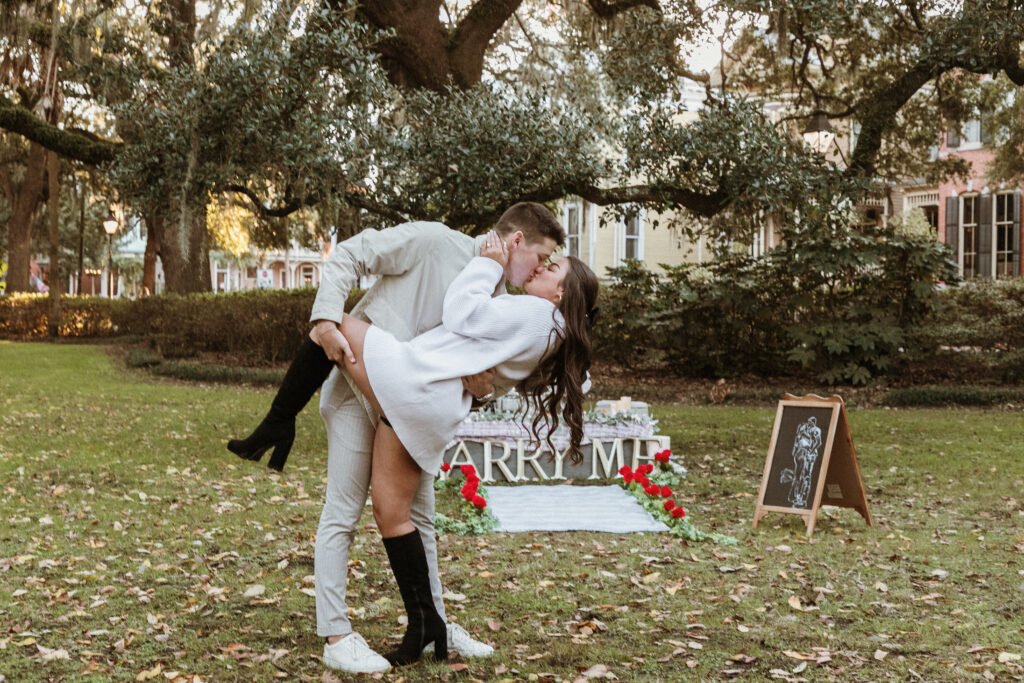 Marriage proposal capture by photographer Lisa Staff with picnic set up at Forsyth Park, Savannah