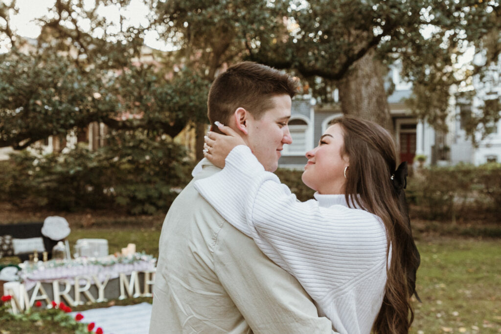 Marriage proposal capture by photographer Lisa Staff with picnic set up at Forsyth Park, Savannah