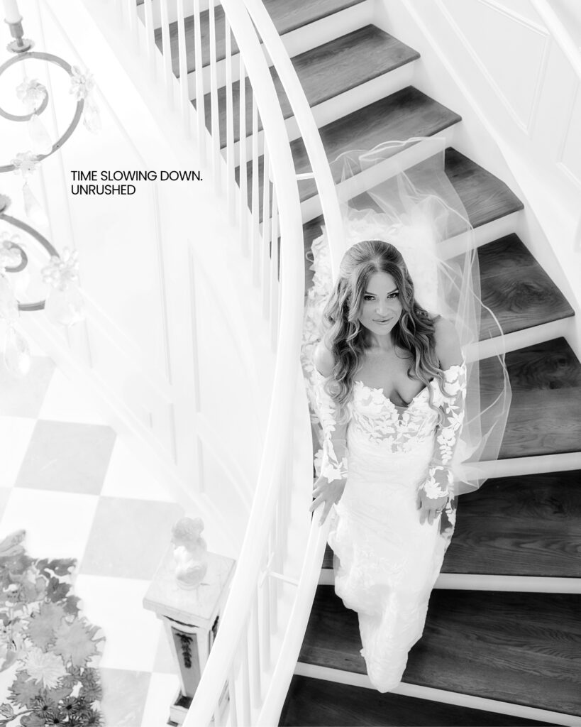 A bride walking down a circular stairway at Hewitt Oaks