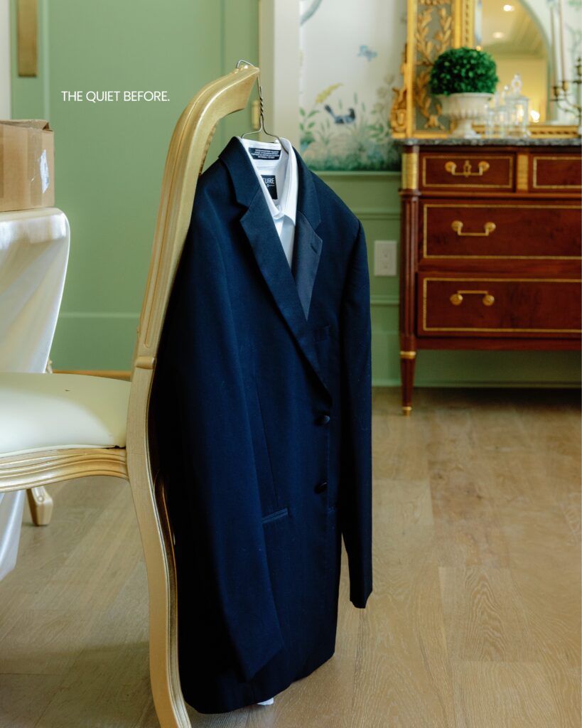 A tuxedo on a haner in an french style room with antiques at Hewitt Oaks before the wedding
