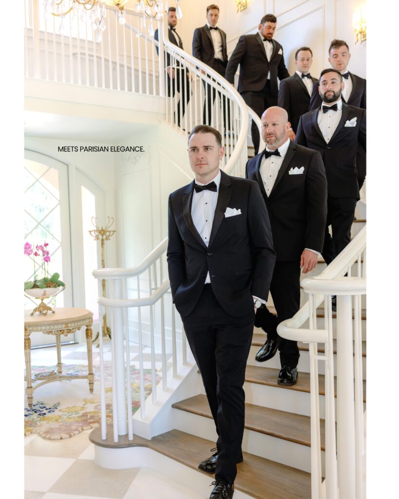 groomsmen in black tuxedos descending down a spiral stairway at Hewitt Oaks