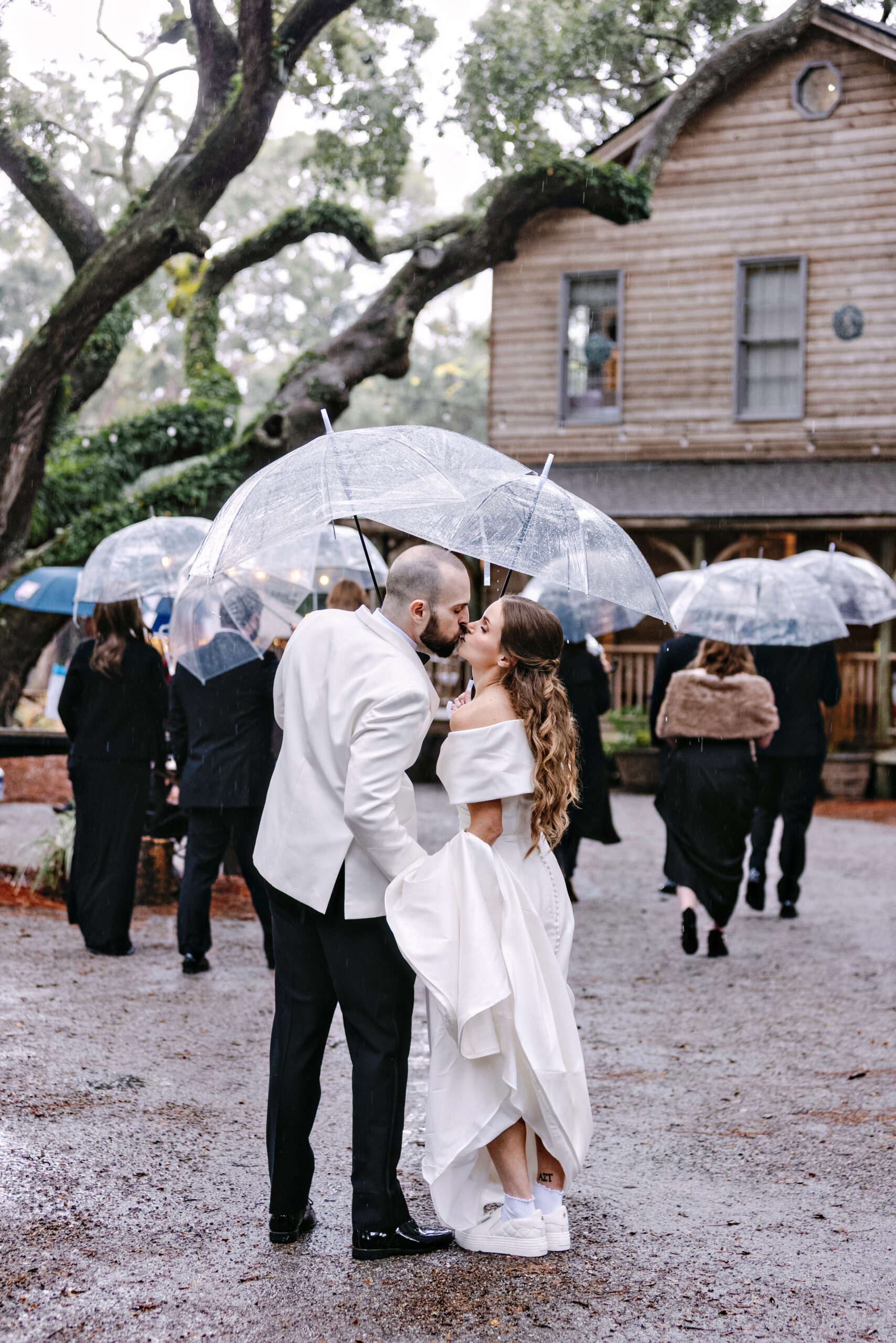a wedding couple kissing under umbrella on their wedding day in Hilton Head
