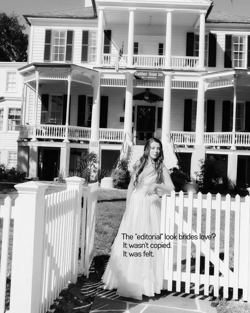 Bride in front of historical home called the Cuthbert House in Beaufort posing by a white picket fence with her dress blowing