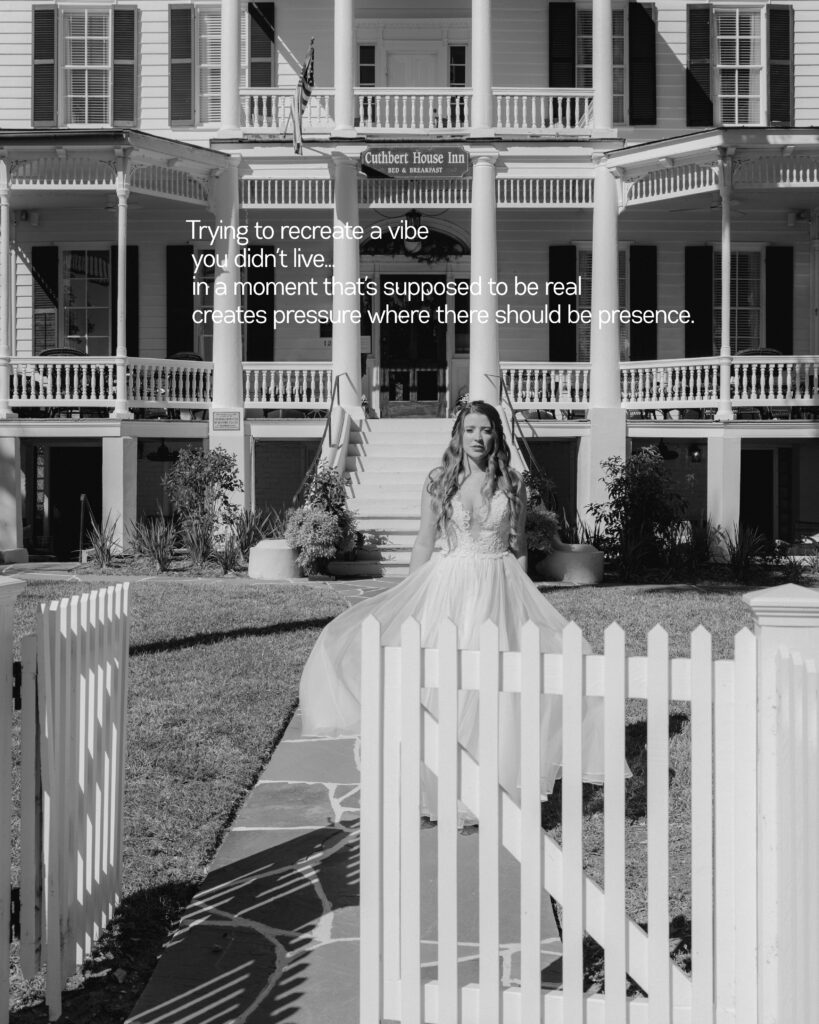 Bride standing in front of a white picket fence at the Cuthbert House in Beaufort