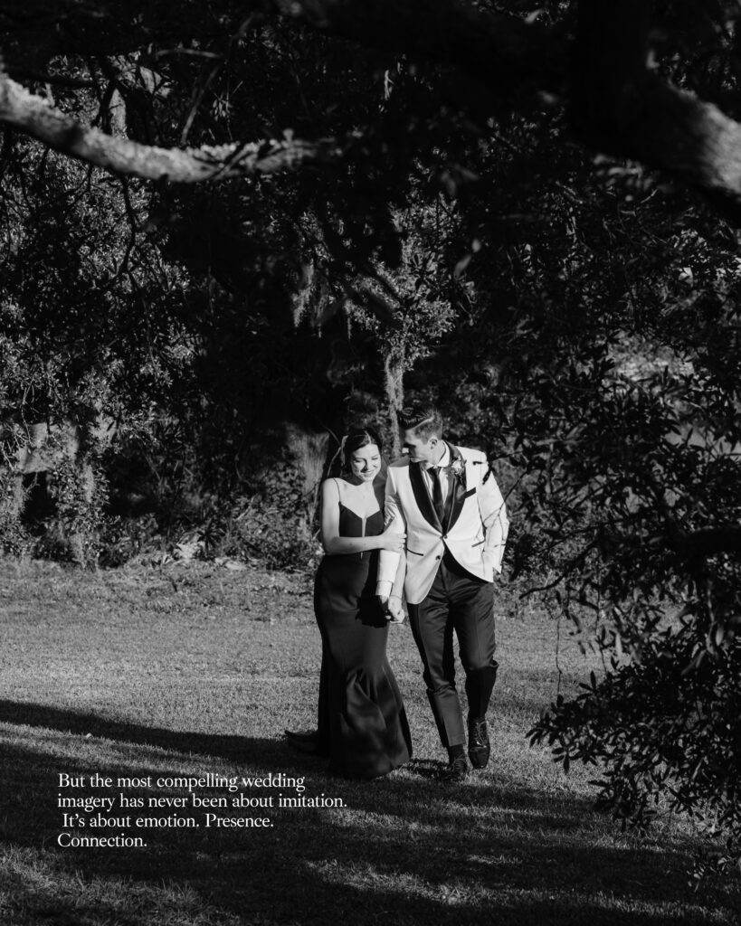 A bride and groom walking hand in hand under the live oaks in Charleston