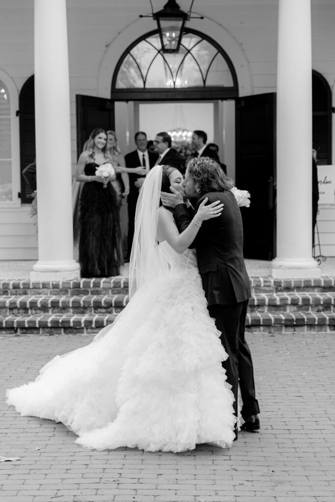 Bride and groom kissing outside of a Palmetto Bluff chapel after their ceremony