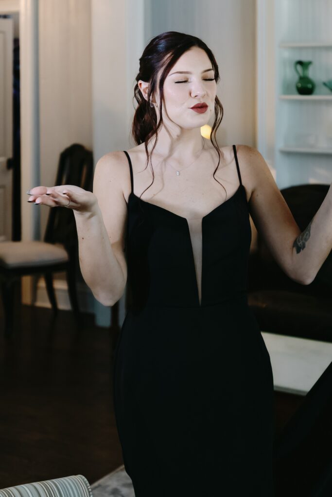 Bride in Charleston wearing a black wedding dress exhaling and being calm before getting married