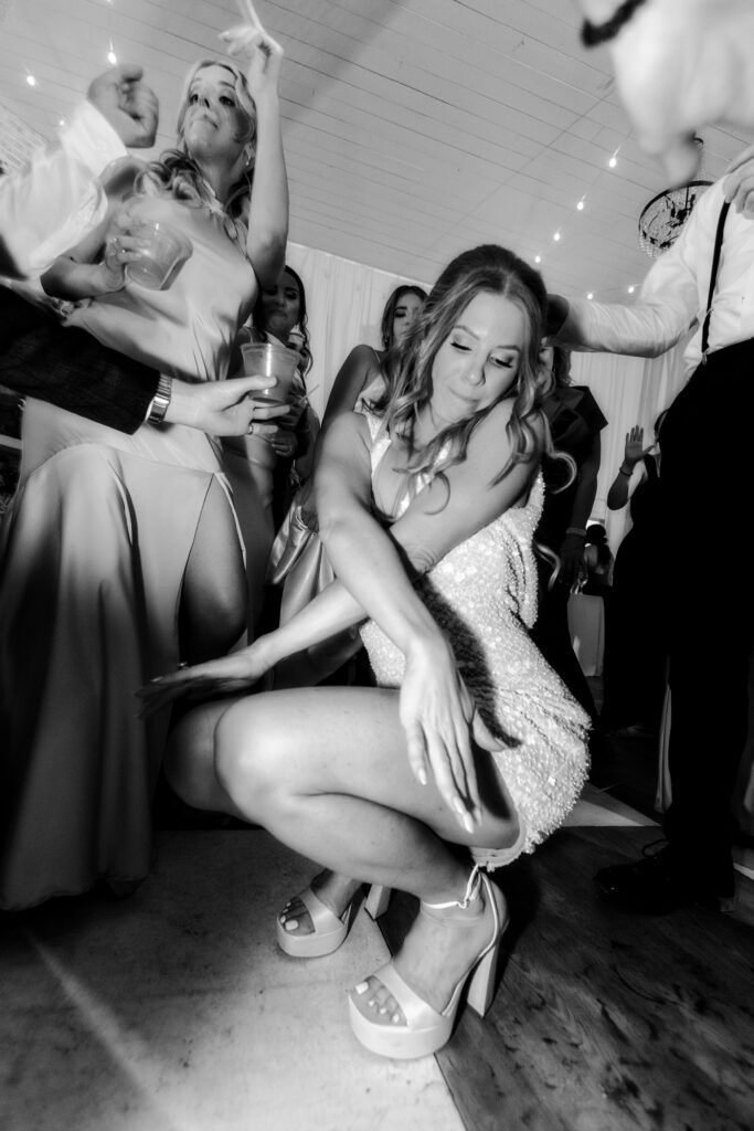 Bride dancing and having a great time during her reception at Hewitt Oaks wearing her second dress