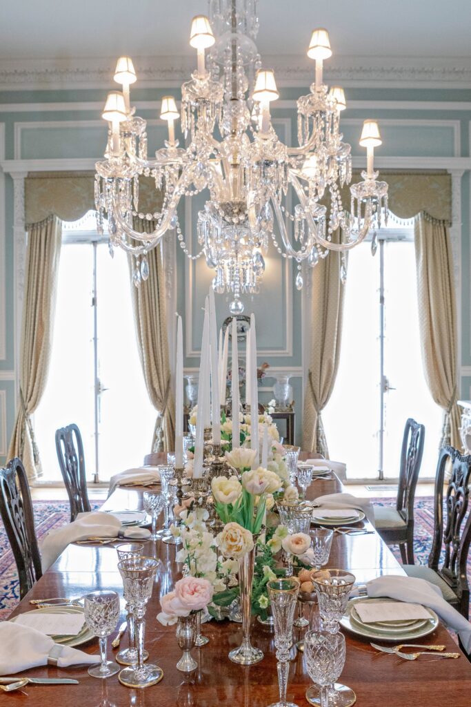 A beautiful french inspired table setting with a chandelier and lush velvet curtains at the Kessler Manion