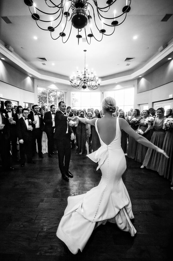 Bride and groom doing their first dance at Sea Pines Country Club with all of their guests in a circle surrounding them